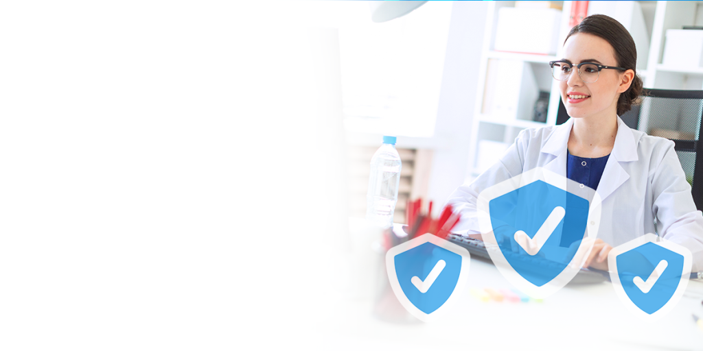 A female dentist smiling while using a computer. She is sitting at a desk, wearing a lab coat and glasses. Three blue shield icons with checkmarks in the middle of each shield icon appear beneath the dentist. The center shield is the biggest, the two shields on either side are smaller.